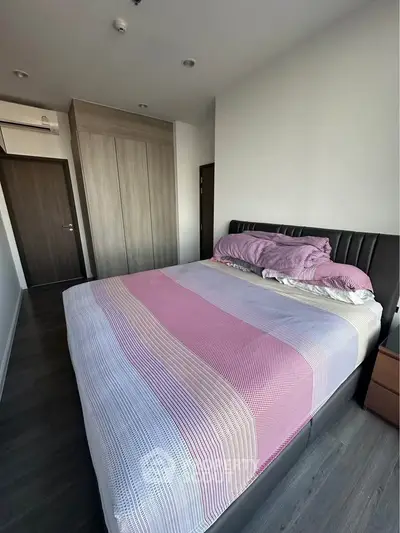 Spacious bedroom with modern design and ample natural light, featuring a large bed and stylish wardrobe.