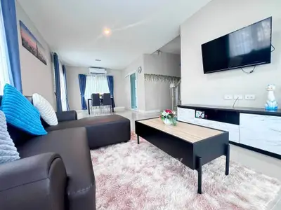 Modern living room with cozy sofa, wall-mounted TV, and stylish decor