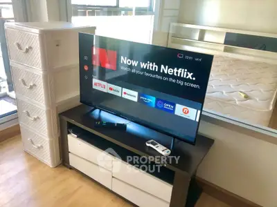 Modern living room with smart TV and stylish furniture, perfect for entertainment and relaxation.