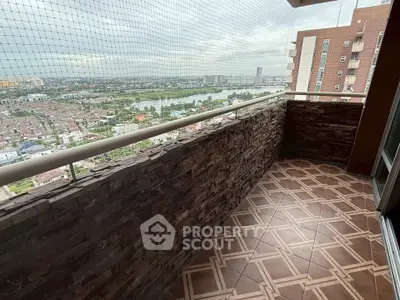 Spacious balcony with stunning city view and tiled flooring in modern apartment.