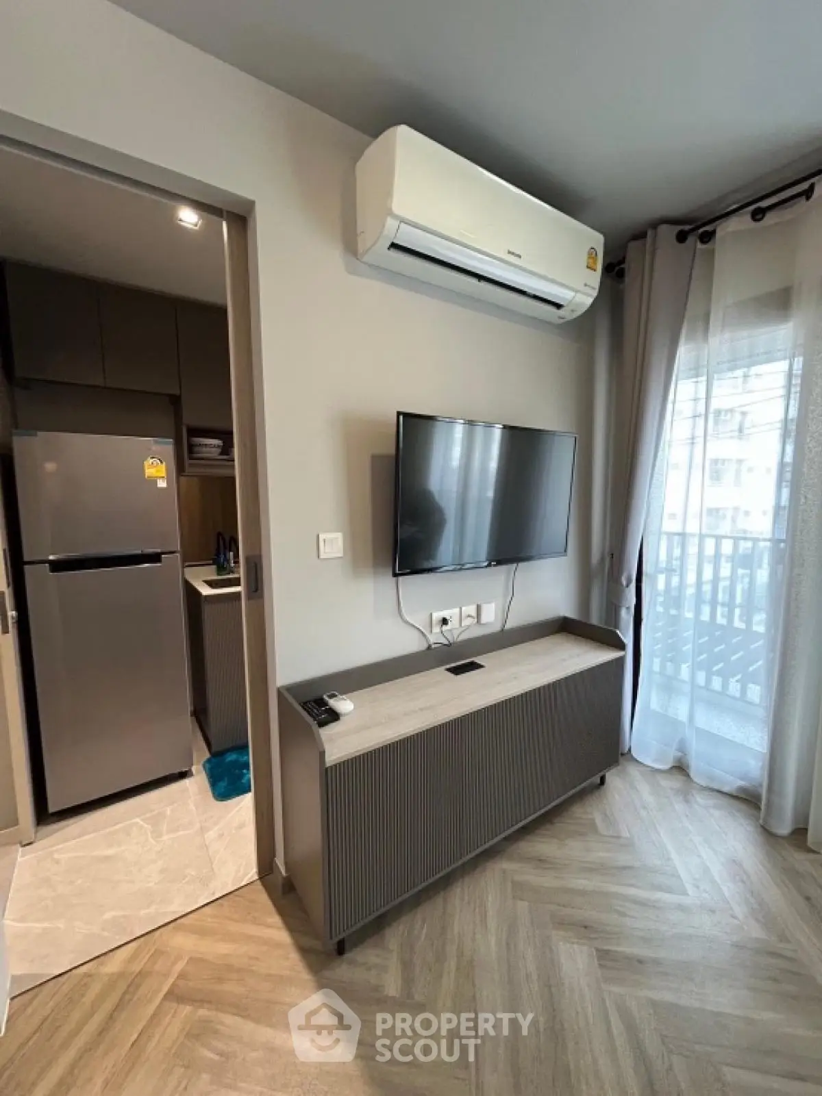 Modern living room with air conditioning and balcony view