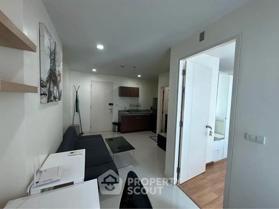 Modern apartment interior with sleek kitchen and cozy living area, perfect for urban living.