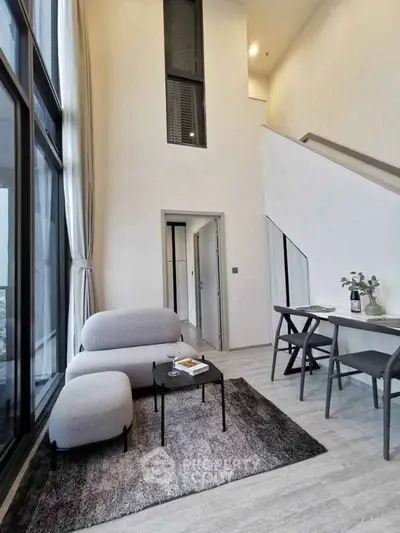 Modern loft-style living room with high ceilings and elegant decor