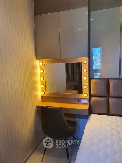 Modern bedroom with stylish vanity mirror and cozy chair, perfect for urban living.