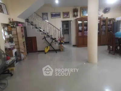 Spacious living area with elegant staircase and modern decor