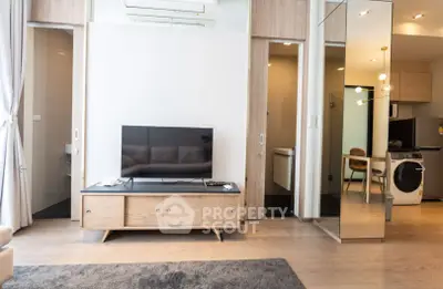 Modern living room with sleek TV stand and open kitchen layout