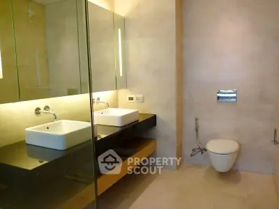 Modern bathroom with dual sinks and elegant fixtures in a luxury apartment.