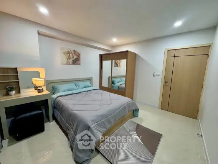 Modern bedroom with stylish decor and ample storage space