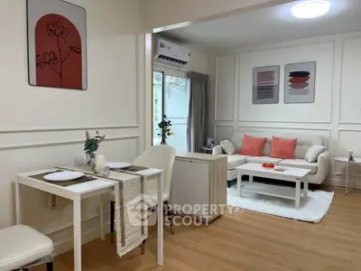 Chic modern living room with dining area, stylish decor, and cozy ambiance.