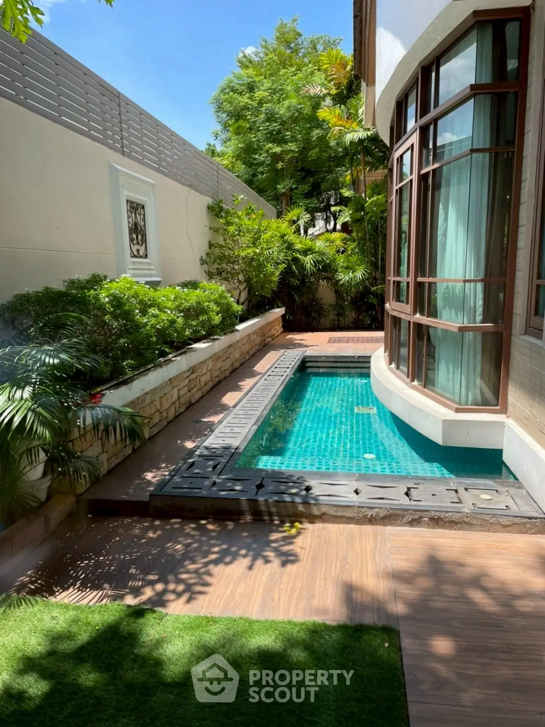 Luxurious private pool with lush greenery and modern architecture