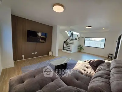 Spacious modern living room with stylish decor and large windows