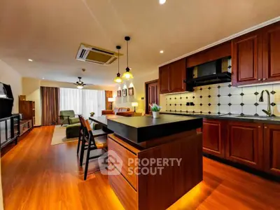 Spacious open-layout kitchen and living room with modern design and warm lighting.