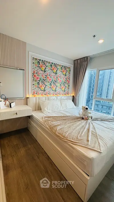 Charming bedroom with floral accent wall and city view, perfect for cozy urban living.