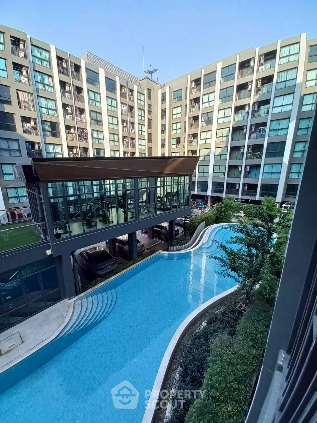 Modern apartment complex with pool and gym facilities, offering luxurious amenities and contemporary living spaces.