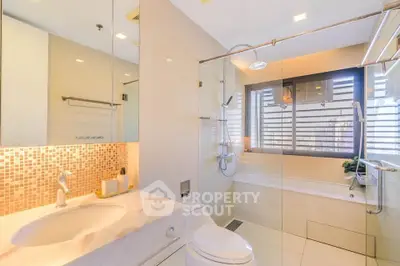 Luxurious bathroom with elegant fixtures and large window for natural light.