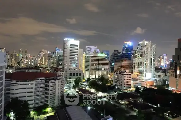 Stunning night view of a vibrant city skyline with illuminated skyscrapers and urban landscape.