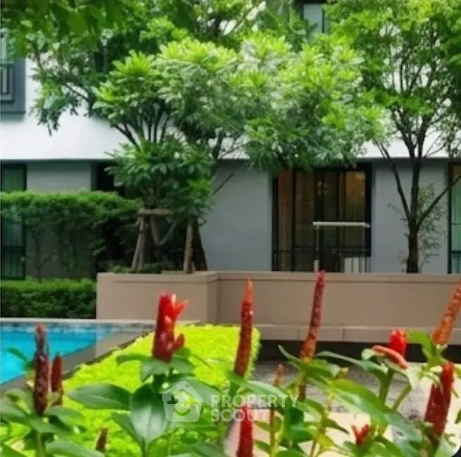 Lush garden view with pool in modern residential complex
