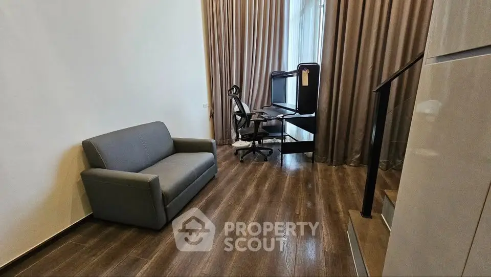 Modern living room with sleek sofa and stylish workspace setup