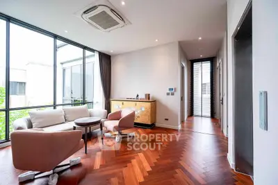 Elegant living room with modern furniture and large windows offering natural light