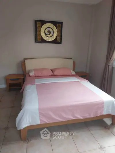 Cozy bedroom with stylish decor and natural light, perfect for relaxation.