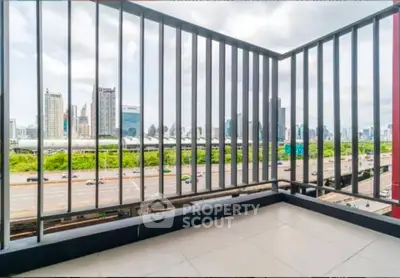 Spacious balcony with stunning city skyline view, perfect for relaxation and enjoying urban living.