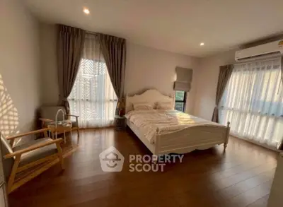 Spacious bedroom with elegant decor and natural light