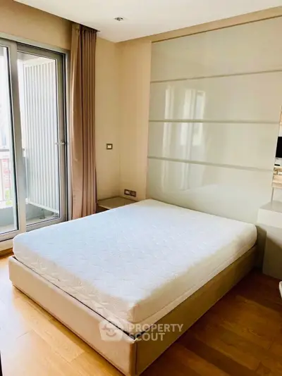Modern bedroom with large window and minimalist design in a luxury apartment.