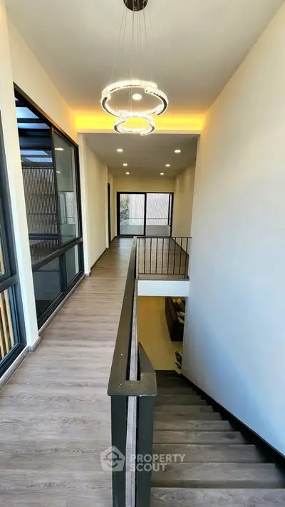 Modern hallway with elegant lighting and wooden flooring in a luxury home