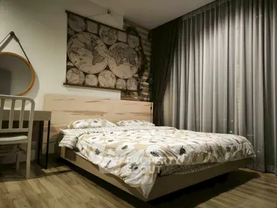 Cozy bedroom with stylish decor and large window for natural light