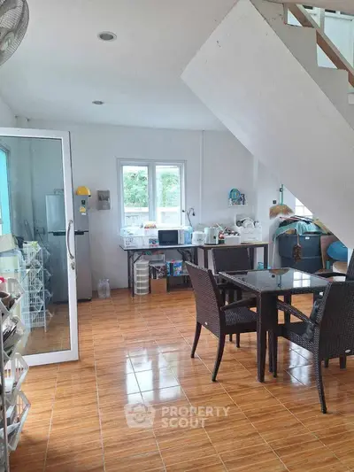 Spacious kitchen with open layout and dining area, featuring modern appliances and stylish flooring.