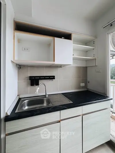 Modern minimalist kitchen with open shelving and sleek countertop