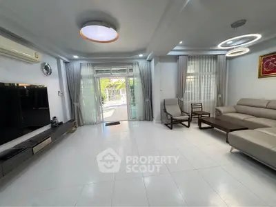 Spacious modern living room with sleek furniture and large windows for natural light.