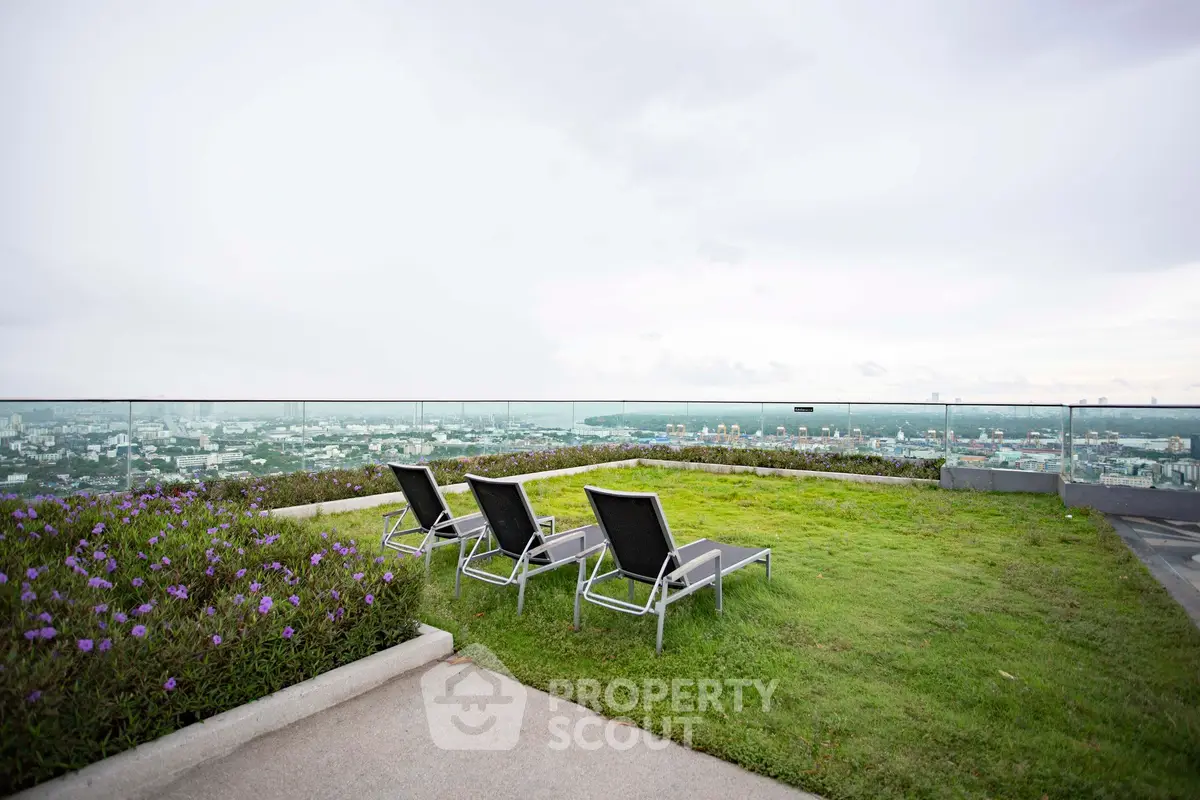Stunning rooftop garden with panoramic city views and comfortable lounge chairs.