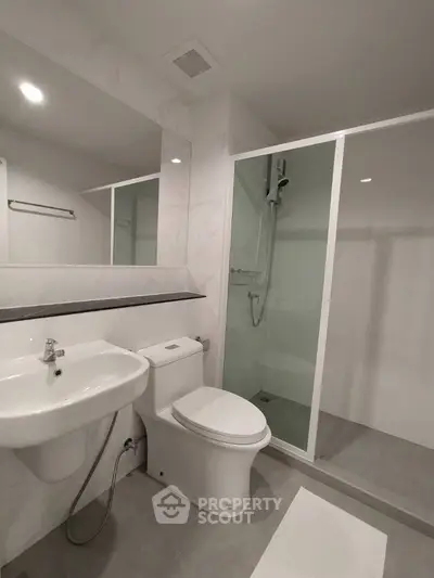 Modern bathroom with sleek fixtures and spacious shower area