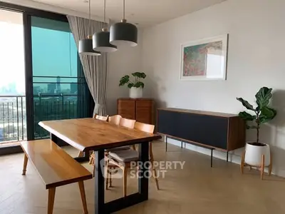 Modern dining area with wooden table, chairs, and balcony view in a stylish apartment.