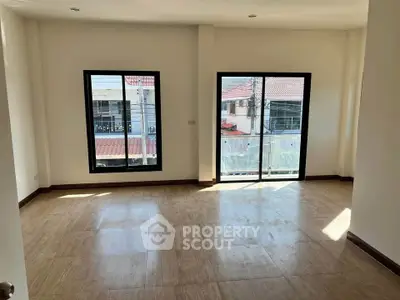 Spacious empty room with large windows and natural light