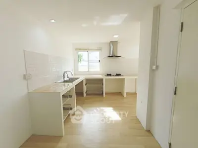Bright minimalist kitchen with gas stove and ample counter space