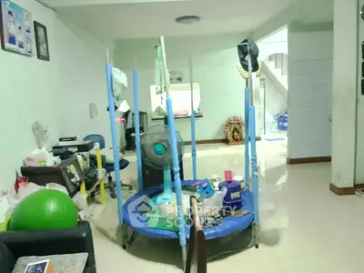Spacious living room with exercise equipment and modern decor