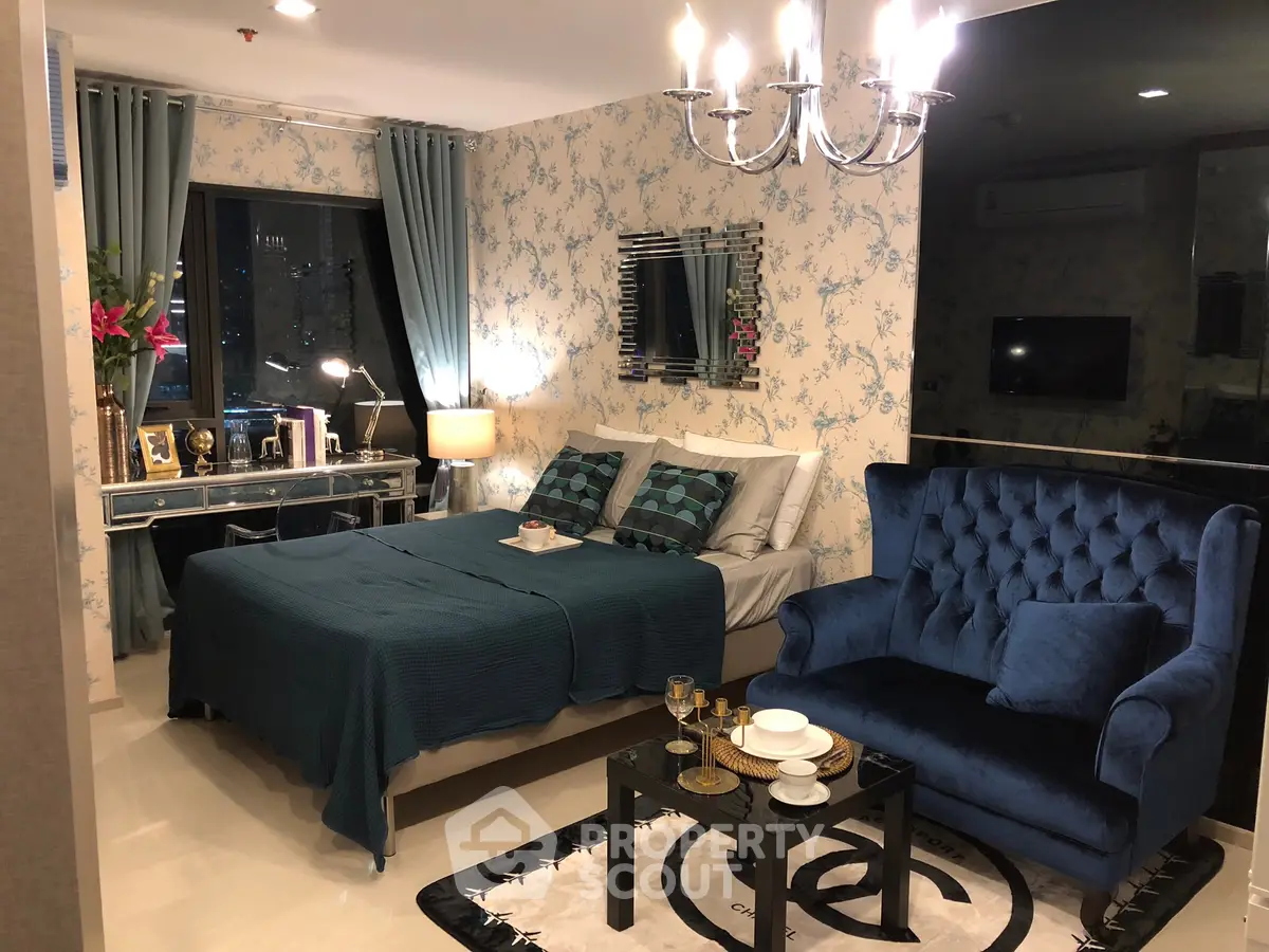 Luxurious bedroom with elegant decor and plush blue seating