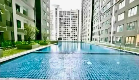 Luxurious condominium with a stunning outdoor pool surrounded by modern high-rise buildings.