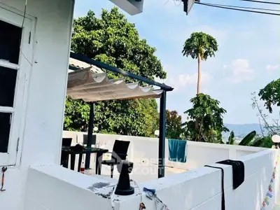 Spacious rooftop terrace with scenic views and outdoor dining area.