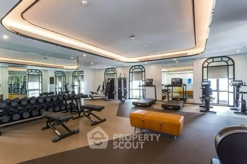 Luxurious gym with modern equipment and stylish design in upscale property.
