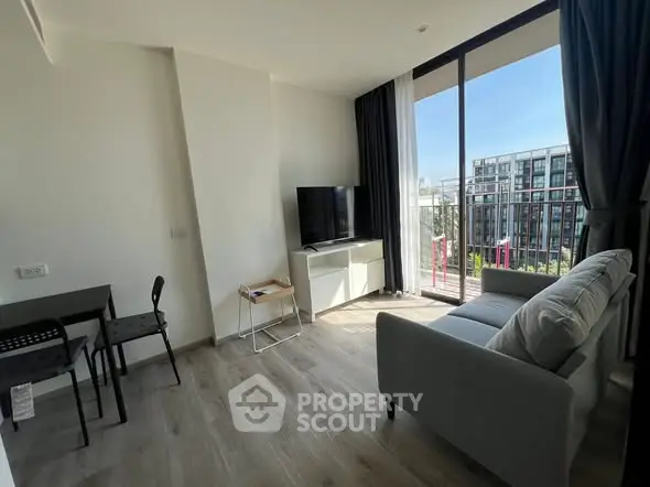 Modern living room with large windows and balcony view