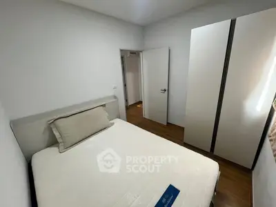 Cozy bedroom with modern wardrobe and comfortable bed in a stylish apartment.