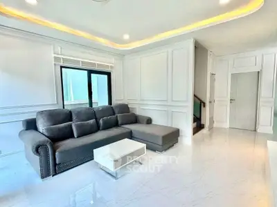 Spacious modern living room with elegant gray sofa and sleek white decor