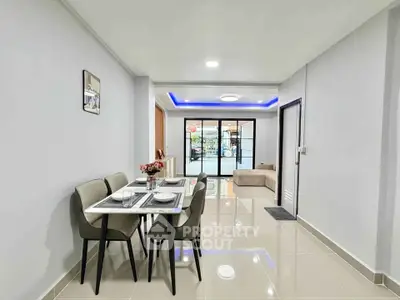 Modern dining area with sleek furniture and open layout in a stylish apartment.