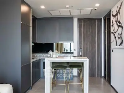Modern kitchen with sleek cabinetry and stylish breakfast bar in a contemporary apartment.