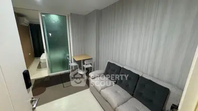 Modern compact living room with cozy sofa and dining area, featuring sleek design and stylish decor.