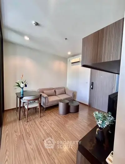 Modern living room with stylish furniture and wooden flooring in a cozy apartment.