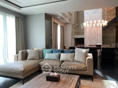 Luxurious living room with elegant sofa and modern dining area, featuring floor-to-ceiling windows and chic lighting.